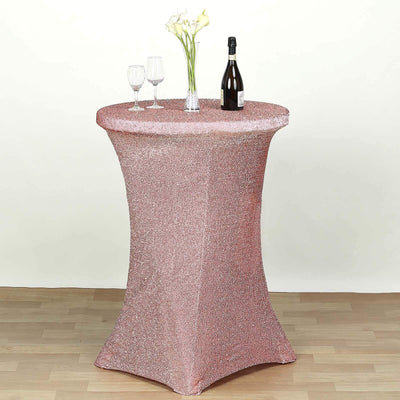 Rose gold sequin table cover with drinks and flowers on a round table.