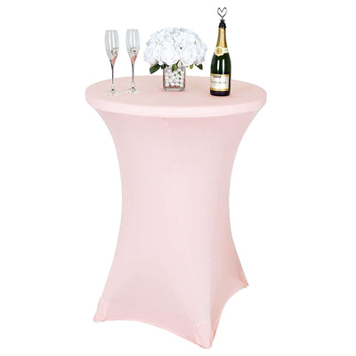 Pink stretch table cover with champagne, flutes, and flowers for events.