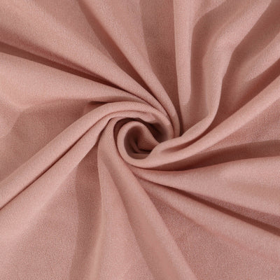 Soft pink fabric with a textured finish, perfect for sewing projects.
