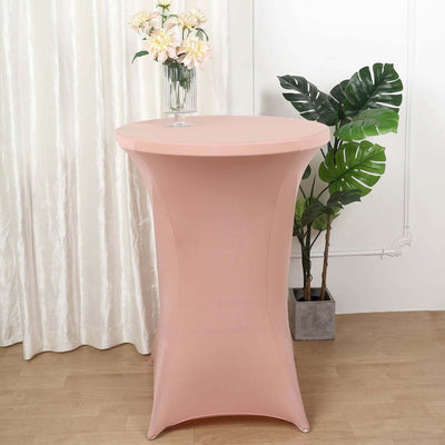 Pink cocktail table with a floral centerpiece and greenery.
