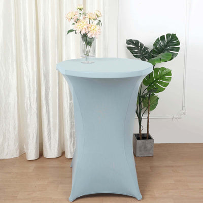 Light blue cocktail table with a floral vase and greenery in a staged setting.