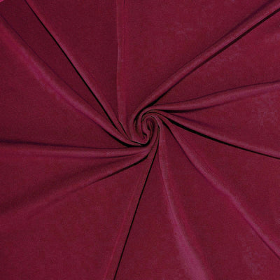 Burgundy fabric in a spiral pattern showcasing smooth texture.