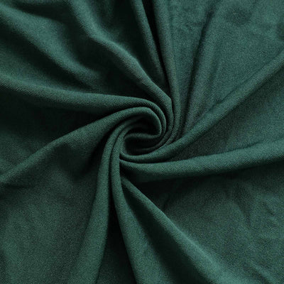 Green fabric swirl close-up showcasing texture and color.