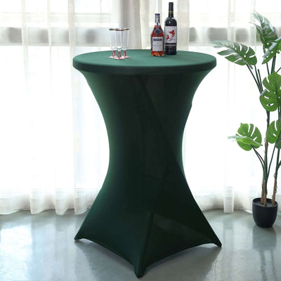 Green cocktail table cover with drinks and decorative plant in a bright setting.