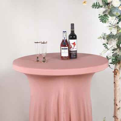 Round pink table with drinks and glasses, set in a styled environment.