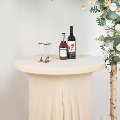 Elegant cocktail table setup with drinks and glasses, adorned with flowers.