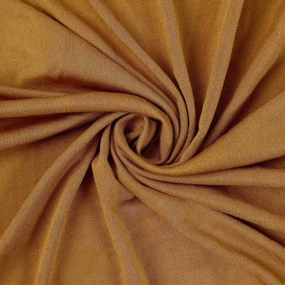 Textured brown fabric swirling in a circular pattern.