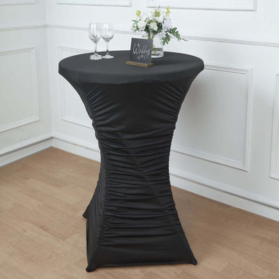 Black fitted table cover for events with elegant draping.