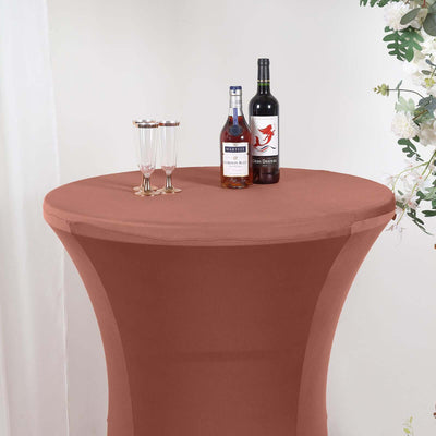 Brown stretch table cover with drinks on a round table.