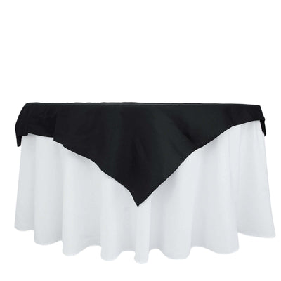 Black tablecloth draped over a white table, showcasing elegant design.