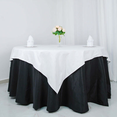 Elegant black and white tablecloth with floral centerpiece and napkins