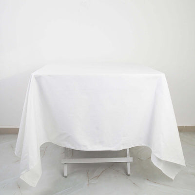 White tablecloth draped over a table in a minimalist setting