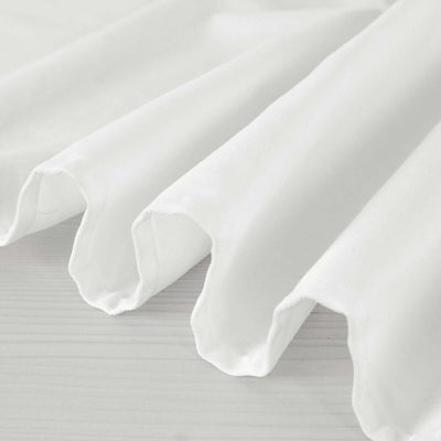 White fabric draped elegantly on a light surface.