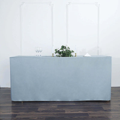 Gray table cover draped over a rectangular table in a staged setting.