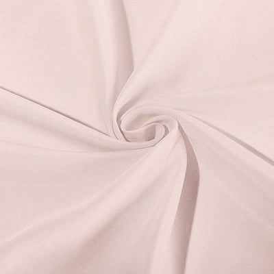 Light pink fabric with a smooth texture, elegantly twisted in a spiral.