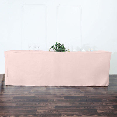Pink table cover draped over a long table in an elegant setting.