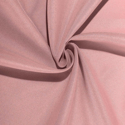 Soft pink fabric swirling in a circular pattern.