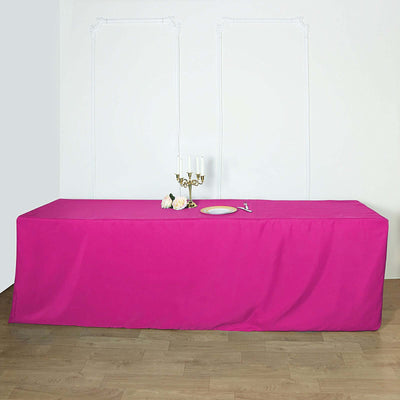 Bright pink tablecloth draped over a table in an elegant setting.