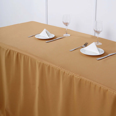 Elegant gold tablecloth draped over a dining table set for two.