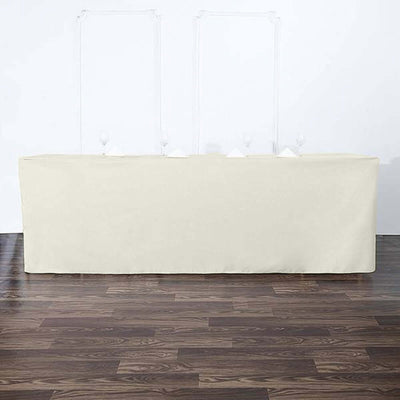Cream table cover draped over a long table in a minimalist setting.