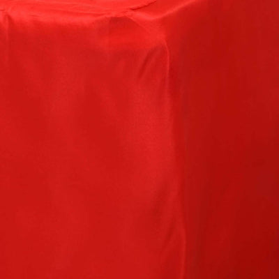 Red satin tablecloth draped over a table surface.