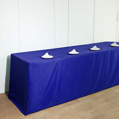 Blue table cover with white napkins on a plain wooden floor.