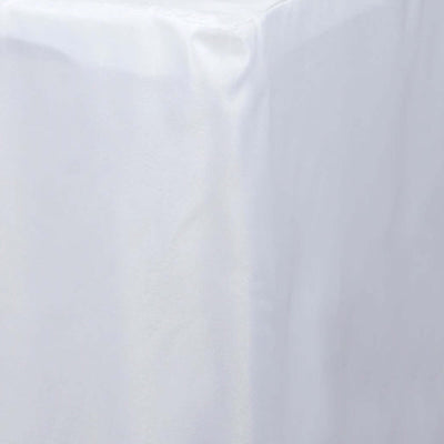 White tablecloth draped over a table edge, showcasing smooth fabric texture.