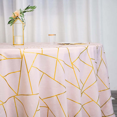 Pink tablecloth with gold geometric pattern on a dining table.