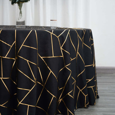 Black tablecloth with gold geometric pattern on a table.