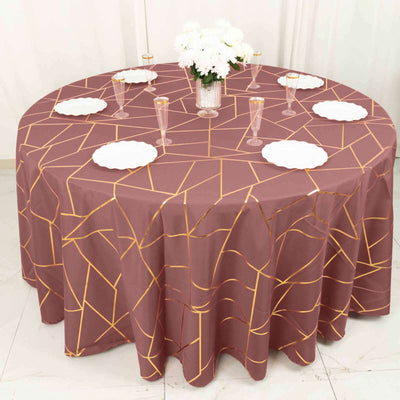 Round geometric patterned tablecloth with gold accents on a dining table.