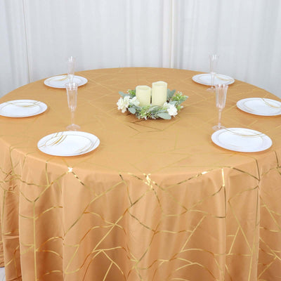 Gold tablecloth with decorative plates and centerpiece in a styled setting.
