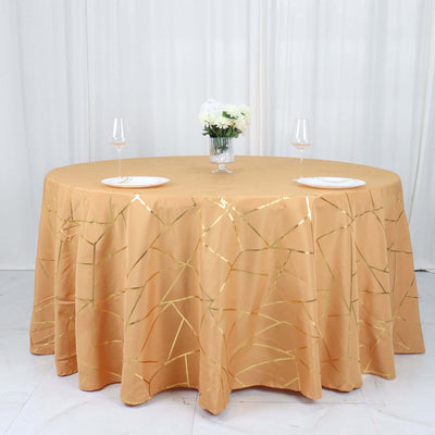 Gold crackle tablecloth on a round table with wine glasses and plates.