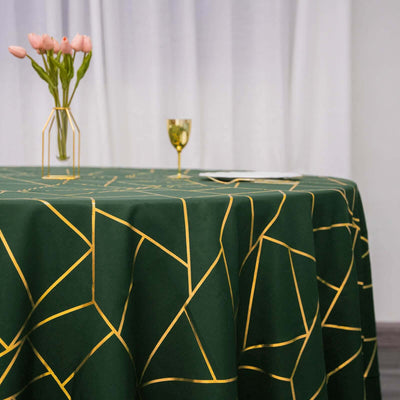Green geometric tablecloth with gold accents on a dining table.