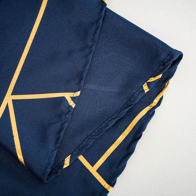 Navy blue fabric with gold geometric pattern and folded edges.