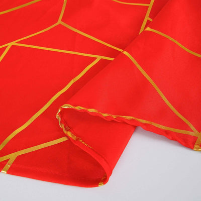 Red tablecloth with gold geometric patterns, showcasing vibrant design details.