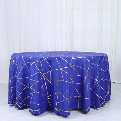 Blue tablecloth with a gold geometric pattern on a round table.