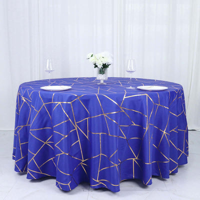 Round blue tablecloth with gold geometric pattern, elegantly set for dining.