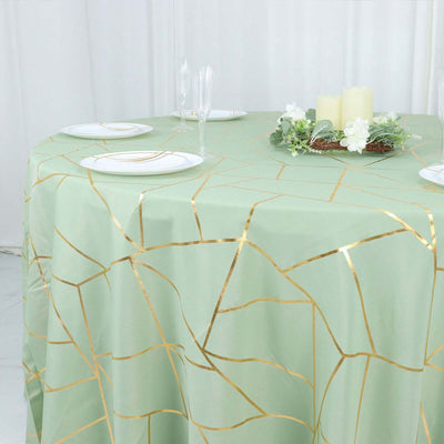 Mint green tablecloth with gold geometric pattern on a round table.