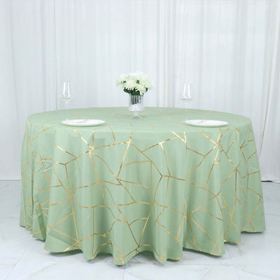 Green tablecloth with gold crackle design on a round table setting.