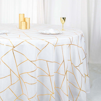 Gold geometric patterned tablecloth on a white table.