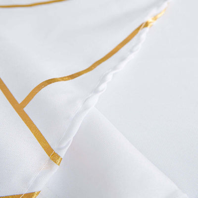 White fabric with gold geometric patterns and textured detail.
