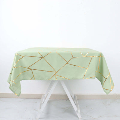 Green tablecloth with gold geometric design on a white backdrop.