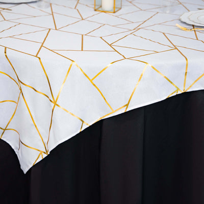 Gold geometric patterned tablecloth on a black table.