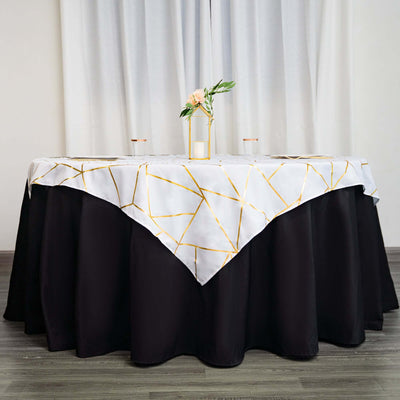 Elegant tablecloth with geometric gold pattern on a black table.