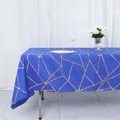 Blue geometric tablecloth with gold accents on a dining table.