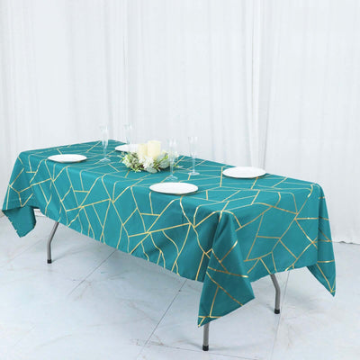 Teal geometric tablecloth on a dining table with plates and decor.