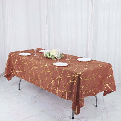 Elegant brown tablecloth with gold geometric pattern, set for a dining occasion.