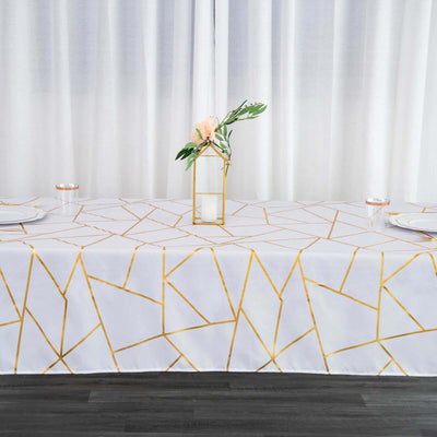 Geometric gold and white tablecloth with a decorative centerpiece.