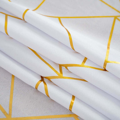 Gold geometric patterned fabric folded neatly.