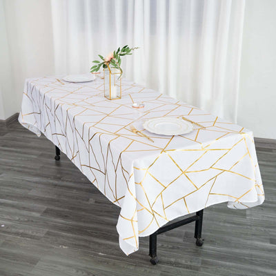Elegant white tablecloth with gold geometric pattern, styled for dining.